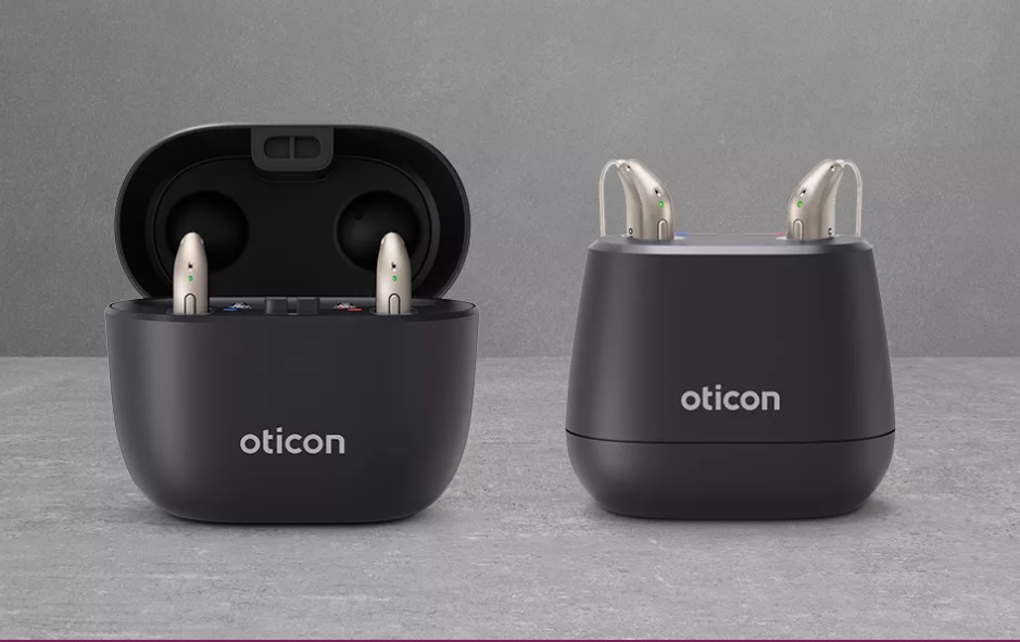 image of oticon hearing aids sitting in a charging station